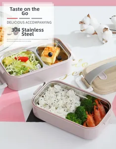 Pink 304 stainless steel bento box with wood-textured handle and partitioned compartments