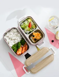 Detail of pink bento box with double stainless steel compartments and wood grain lid