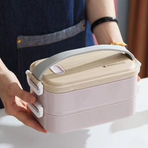 Boîte à lunch bento rose à deux étages avec couvercle aspect bois et poignée grise