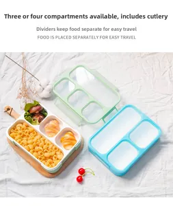 Top view of portable divided lunch boxes with cutlery on a wooden tray and white cloth