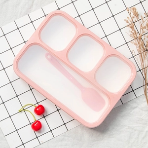 Pink 4-compartment lunch box with spoon on minimalist checkered background and cherry decor