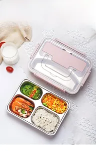Detail of four-compartment stainless steel lunch box with rice, shrimp, and vegetables