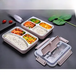 Detail of pink bento box showing stainless steel compartments and cutlery storage lid