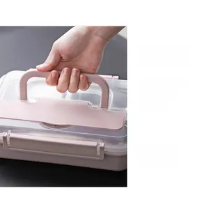Detail of portable pink lunch box lid featuring a sturdy handle and secure side latches