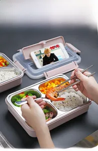 Detail of pink bento box lid featuring a built-in foldable smartphone stand and phone
