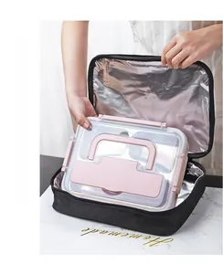 Close-up of placing a pink insulated lunch box into a matching thermal carry bag