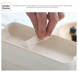 Detail showing the removable cross divider being inserted into the wheat straw lunchbox