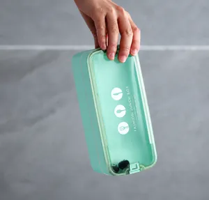 Detail of the leak-proof seal and secure side buckles on a mint green wheat straw lunch box