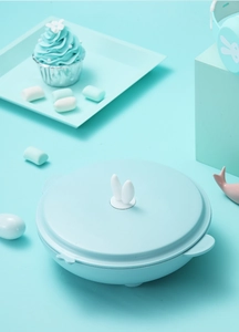 Detail of mint green insulated kids bowl with rabbit ear lid and ergonomic dual handles