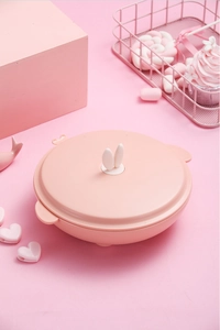 Close-up of pink round children lunch box with cute white rabbit ear lid handle