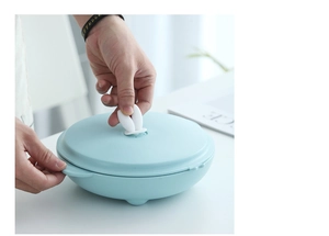 Detail of light blue round storage container featuring a cute white rabbit ear handle