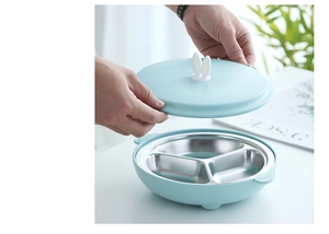 Detail of blue bunny-eared lid being opened on a 3-compartment stainless steel baby bowl