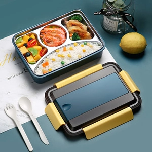 Detail of 4-compartment stainless steel lunch box with rice, shrimp, and fruit