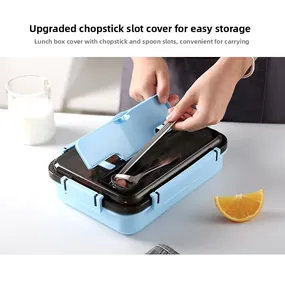 Close-up of integrated cutlery storage compartment with stainless steel spoon and fork