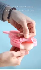 Detailed view of pink flexible silicone brush with built-in sponge and soft cleaning bristles