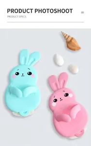 Close-up of cute rabbit-shaped silicone kitchen hooks in pastel green and pink colors