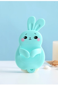 Detail of blue rabbit silicone holder with hooks for toothbrushes and kitchen tools