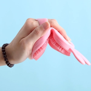Flexible pink silicone massage brush for scalp and body cleaning with rabbit ear handle