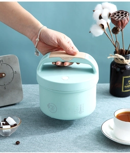 Close-up of portable 304 stainless steel electric lunch box with wood grain handle and sensor