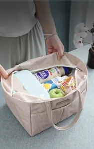 Macro view of beige thermal lunch bag with interior aluminum foil and high capacity space