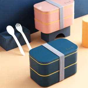 Japanese style double-layer lunch box with utensils and elastic strap in blue and pink
