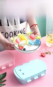 Detail of pink and blue silicone popsicle molds with heart-shaped handles and animal shapes