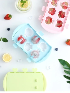 Silicone popsicle mold featuring cute animal shapes with fresh fruit slices and mint