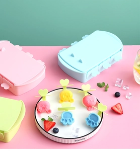 Detail showing cat paw and animal shaped silicone popsicle molds in macaron colors