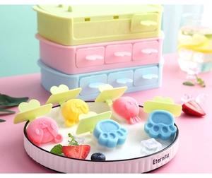 Detail of cat paw and animal shaped silicone popsicle molds in soft pastel colors