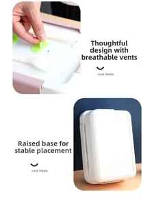 Detail of pink bento box showing the air vent, cutlery storage, and anti-slip base