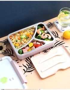 Detailed view of pink three-compartment stainless steel lunch box with cutlery storage