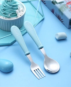 Close-up of portable blue stainless steel kids spoon and fork set with cute handle