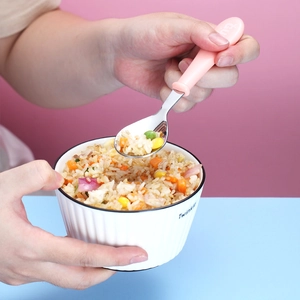 304 stainless steel kids training spoon with ergonomic pink handle scooping colorful rice