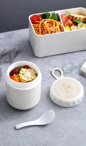 Japanese style portable breakfast cup with handle and lunch box on marble tabletop