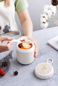 Portable double-layer breakfast soup cup with handle and spoon in a lifestyle setting