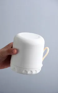 Leak-proof test showing an inverted white breakfast cup with sealed silicone ring