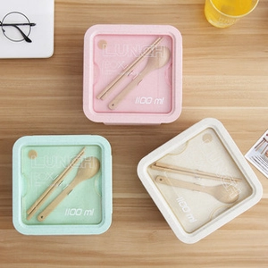 Three-color 1100ml bento boxes with wooden cutlery set on a wooden table surface