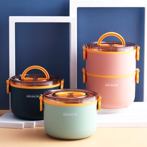Three multi-layer round lunch boxes in blue, green and pink with handles and side locks