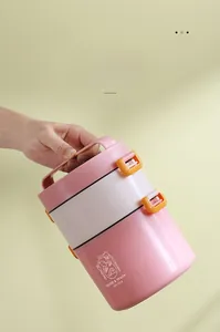Close-up of portable pink plastic lunch box featuring a sturdy handle and side locks