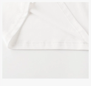 Detail shot of precise double-needle stitching on white cotton t-shirt hemline