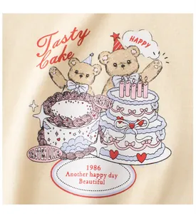 Detailed close-up of cartoon teddy bears and party cake print on cotton kids t-shirt