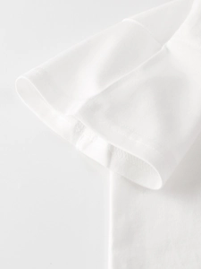 Detailed view of white cotton T-shirt sleeve with high-quality double-needle stitching