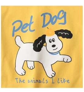 Detail of soft yellow cotton fabric featuring a cute cartoon dog print and text