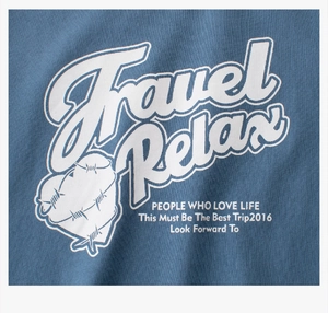 Detail of white screen-printed heart and Travel Relax text on blue cotton T-shirt