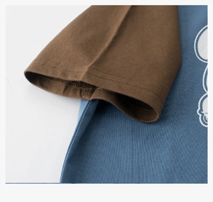 Close-up of raglan sleeves and cotton fabric texture on kids blue and brown t-shirt