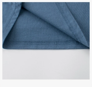 Close-up of double-stitched hem on a navy blue cotton t-shirt with knit texture