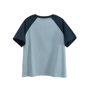 Detail of gray and navy blue raglan sleeves on a loose casual cotton t-shirt for children