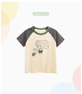 Detail of toddler raglan T-shirt with cartoon elephant and turtle print on beige fabric