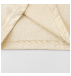 Detailed macro view showing the fine double-needle stitching on kids' cotton T-shirt cuff