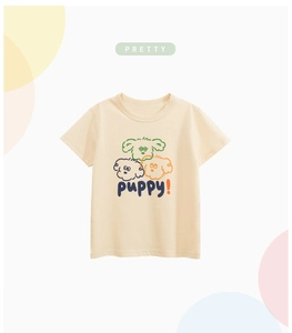 Close-up of a light beige kids' summer t-shirt with three cute cartoon puppy prints